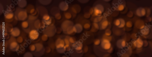 Abstract blurred orange confetti spots on a black background.
