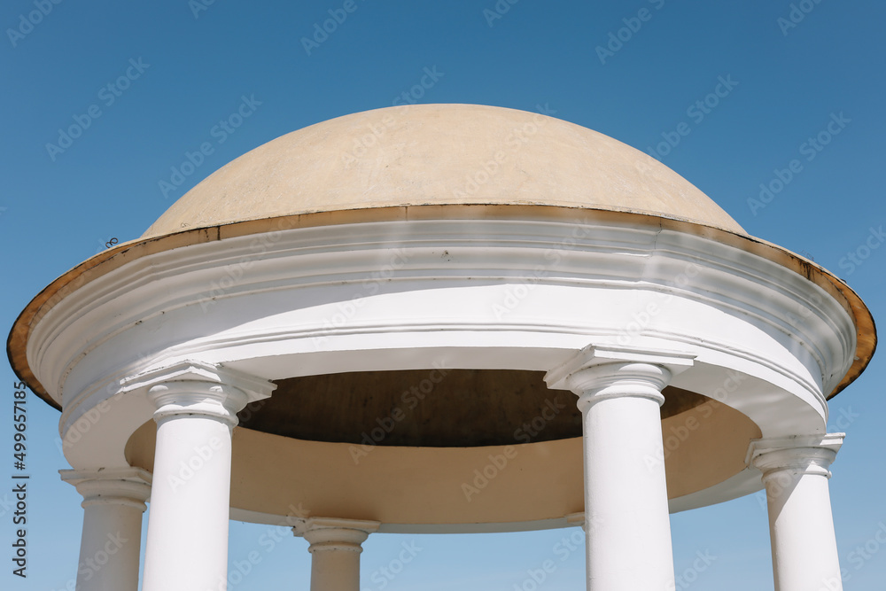 Rotunda against a blue sky. Ancient temple with dome