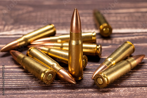 Bullets on wooden background. Cartridges 7.62 caliber for ak 47 closeup. Selective focus