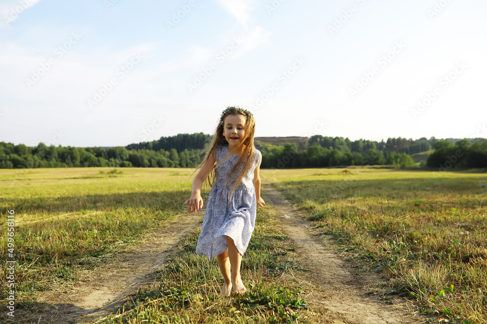 Children walk in the summer in nature. Child on a sunny spring morning in the park. Traveling with children.