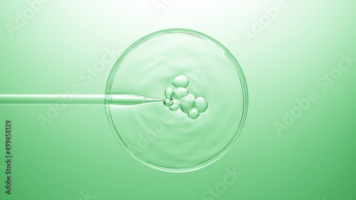 Top view shot of air bubbles coming out from lab dropper and floating on the surface of clear fluid in petri dish bursting on green background | Abstract skin care ingredients mixing concept