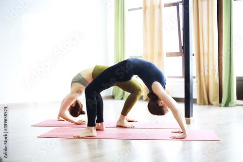 Attractive woman with perfect body in a sports clothes standing in a yoga pose. Concept of sports healthy lifestyle, nutrition and training workout.