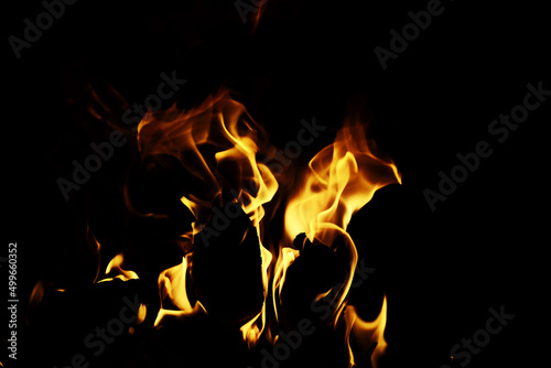 Background of the flame in the oven. Overlay layer. Tongues of fire in a brick fireplace.