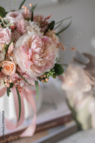 Bouquet with roses, hydrangea. Stabilized flowers in a white ceramic vase at home on the dressing table. Interior decor.