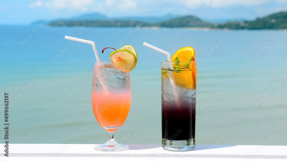 Obraz premium Fresh cold iced cocktail on tropical beach with blue sea at hot sunny day. Summer sea vacation and travel concept