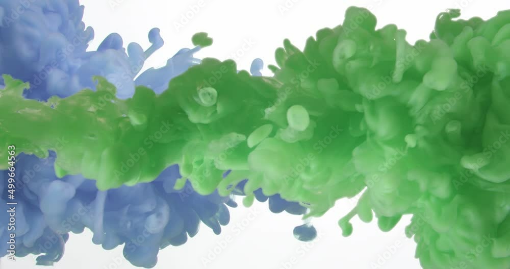 Abstract splashes of green and blue paint in water on white background Abstract splashes of green and blue paint in water on white background