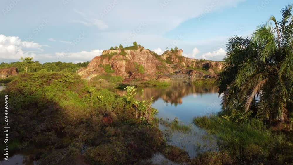 Aerial view move from shade toward abandoned quarry with reflection beautiful lake Aerial view move from shade toward abandoned quarry with reflection beautiful lake