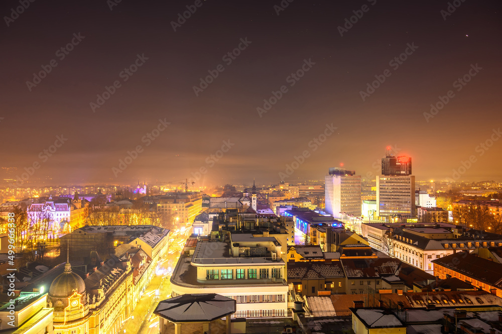 View on the city of Ljubljana from a skyscraper during sunset to night