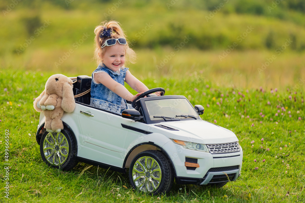 child rides in his car in nature child rides in his car in nature