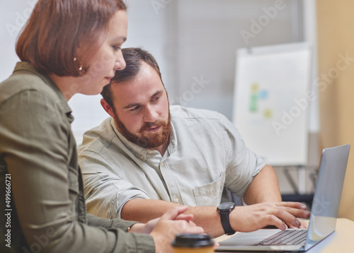 I see the issue. Cropped shot of two corporate businesspeople working together on a laptop in their office.