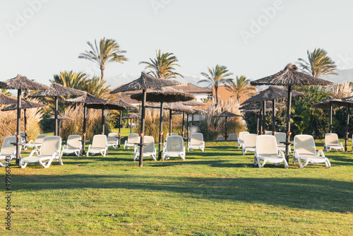 Sunset at the luxury beach resort with sunbeds and umbrellas and golf course in Motril in southern spain, © AnaMara