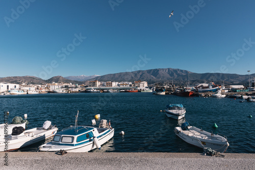 boats moored at the marina with calm sea and blue sky in motril, Andalucia Spain. photo