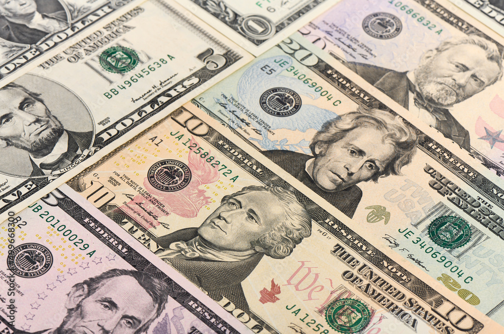 Background of cash dollar bills of different denominations close-up Background of cash dollar bills of different denominations close-up