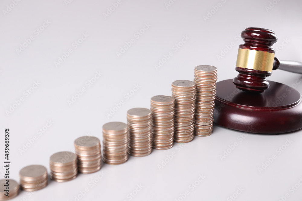 Stacks of coins and court gavel financial crimes Stacks of coins and court gavel financial crimes