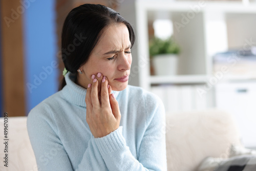 Photos Young woman with severe toothache at home