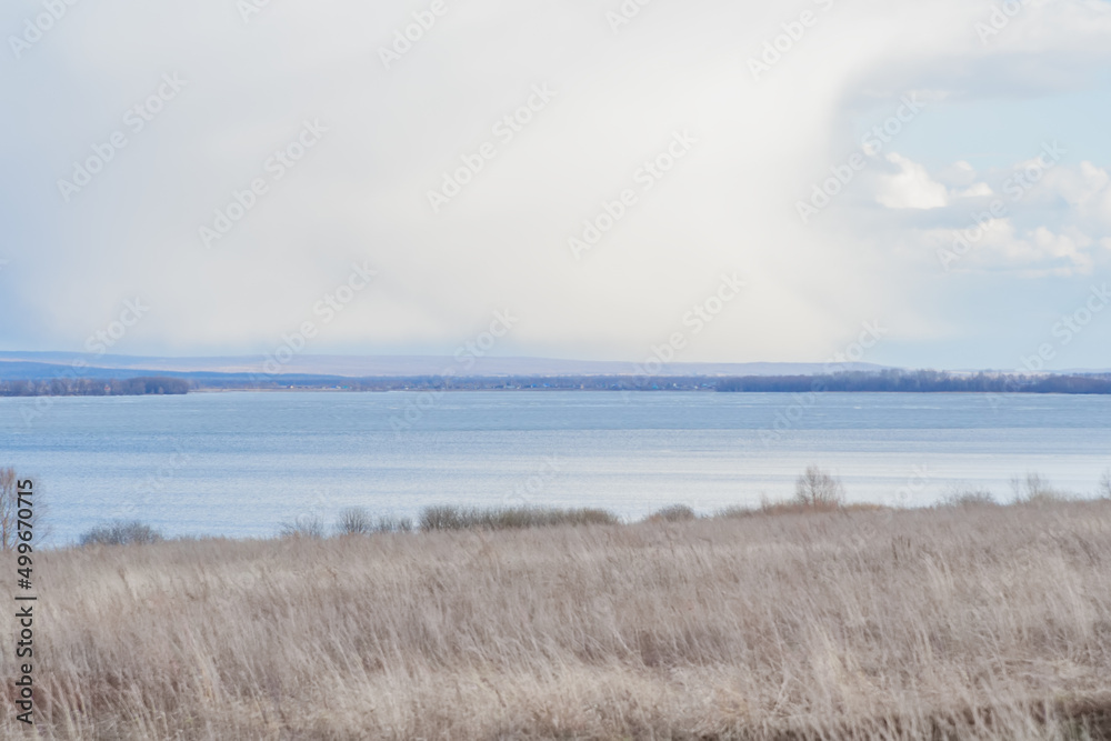 Scenic spring landscape with dry grass on field. Scenic spring landscape with dry grass on field.