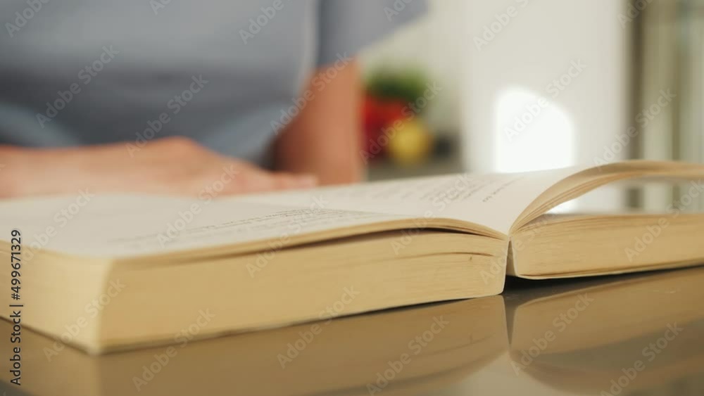 Close up hand turning pages of book. Person reading novel. Close up hand turning pages of book. Person reading novel.