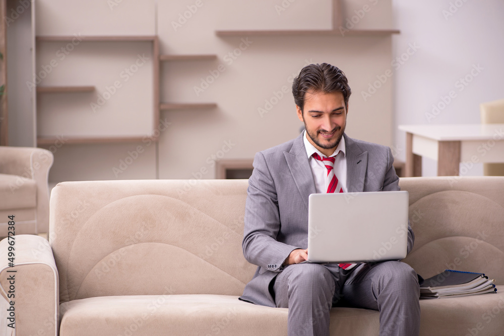 Young male employee working from home during pandemic Young male employee working from home during pandemic