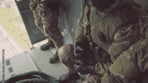 Man in military uniform dress gray leather gloves on sunny day.War between Ukraine and Russia. Military operations in Ukraine. Close-up.Soldier wears leather gloves.Close-up