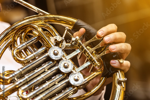 French horn instrument, hands playing horn player in philharmonic orchestra