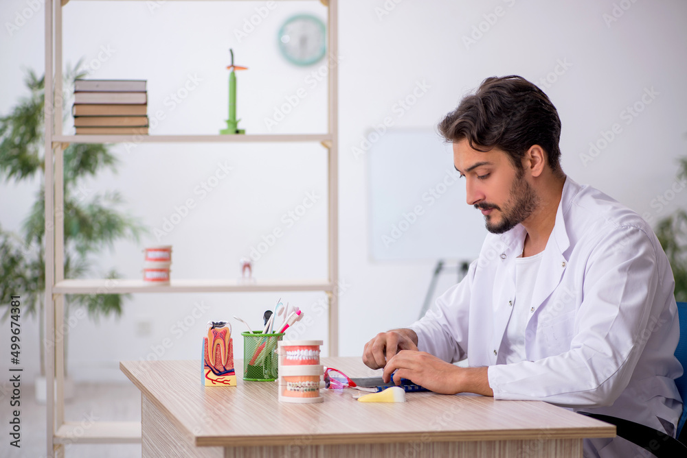 Young male dentist working in the clinic Young male dentist working in the clinic