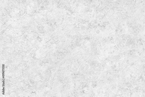 Abstract light grey plastered textured grunge background in the form of a rough covered stucco wall, closeup