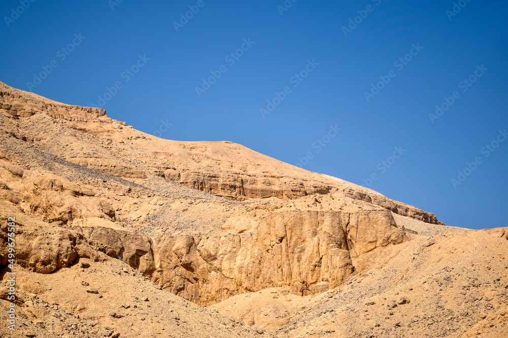 Desert landscape in Egypt. View of sandy hill against clear blue sky. Copy space for text. Selective focus.