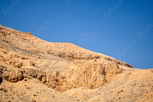 Desert landscape in Egypt. View of sandy hill against clear blue sky. Copy space for text. Selective focus.