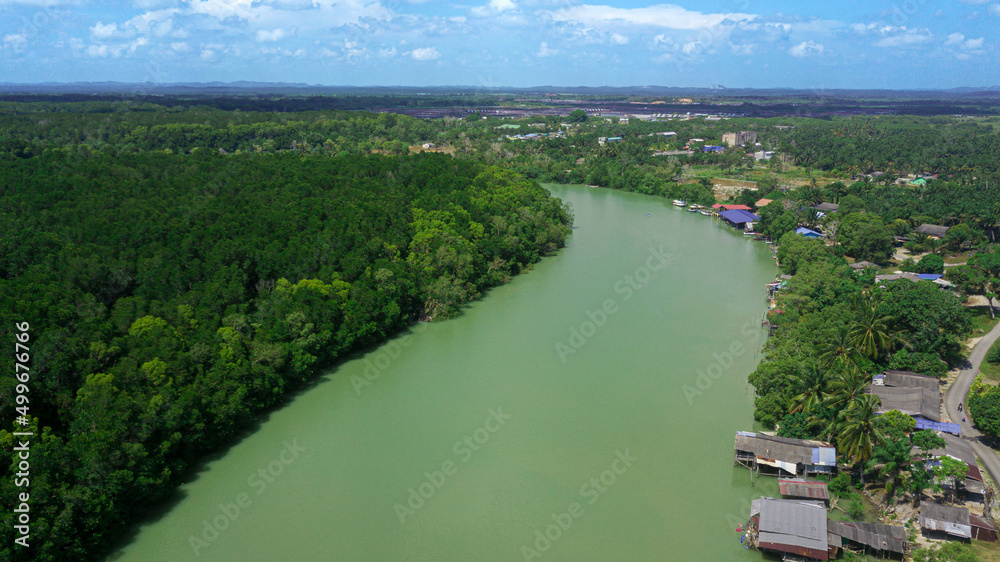 Aerial drone view of rural settlements by the riverside in Sedili Kecil, Johor, Malaysia Aerial drone view of rural settlements by the riverside in Sedili Kecil, Johor, Malaysia