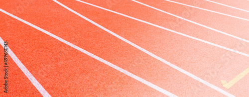 Red runninng race track with border lanes closeup, Treadmill at stadium, Summer sport and fitness concept