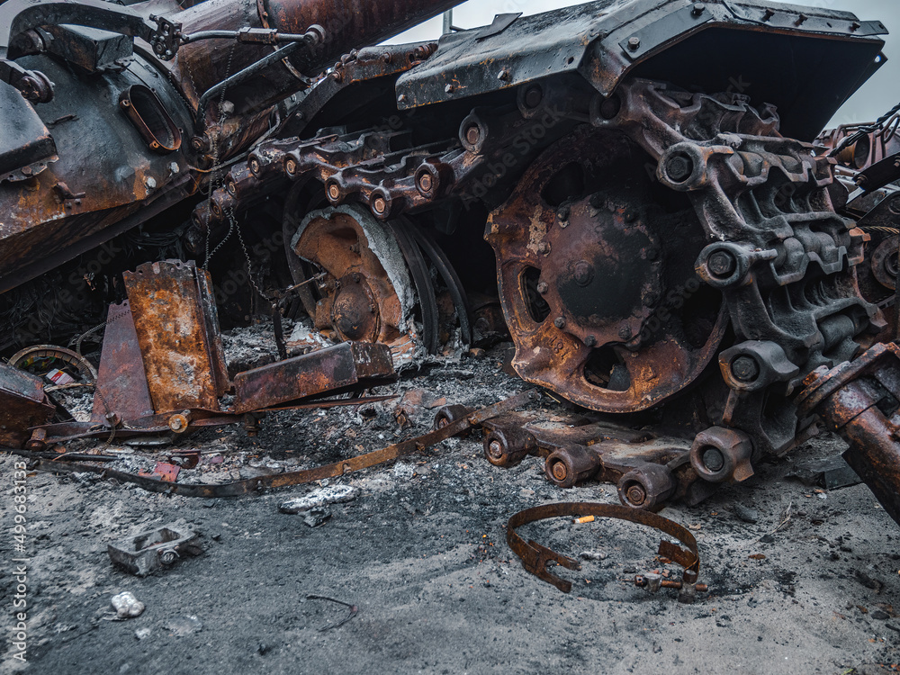 Fototapeta premium War in Ukraine, Zhytomyr highway, Kyiv region, a destroyed Russian tank with a torn off turret stands on the highway.