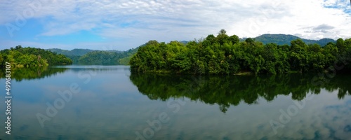 Panoramic shot of dam water surrounded with green trees in Kuala Kubu Bharu, Selangor, Malaysia.