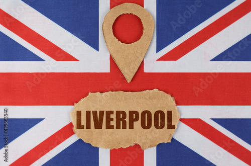 Fototapeta On the flag of Great Britain lies a symbol of geolocation and cardboard with the