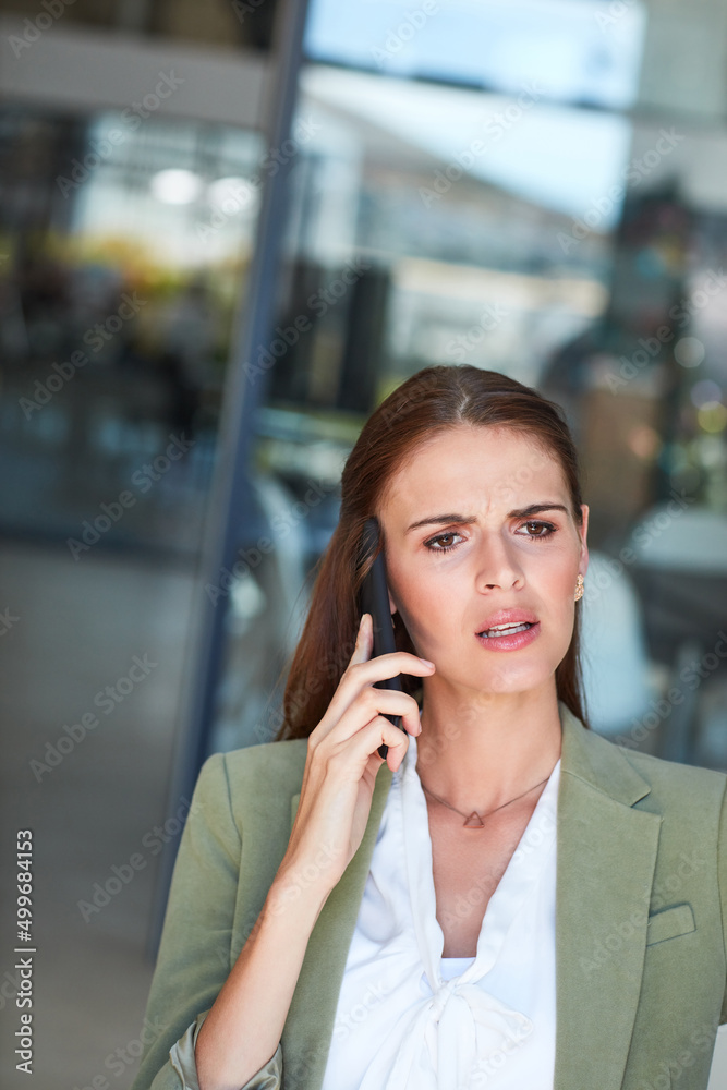 I dont understand...can you explain that again. Shot of a young businesswoman using a mobile phone and looking annoyed in a modern office. I dont understand...can you explain that again. Shot of a young businesswoman using a mobile phone and looking annoyed in a modern office.