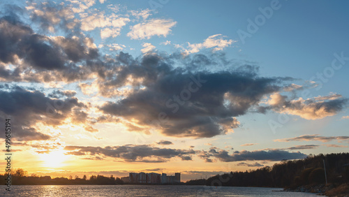colorful sunset on the Neva River with a bright sunny path on the water