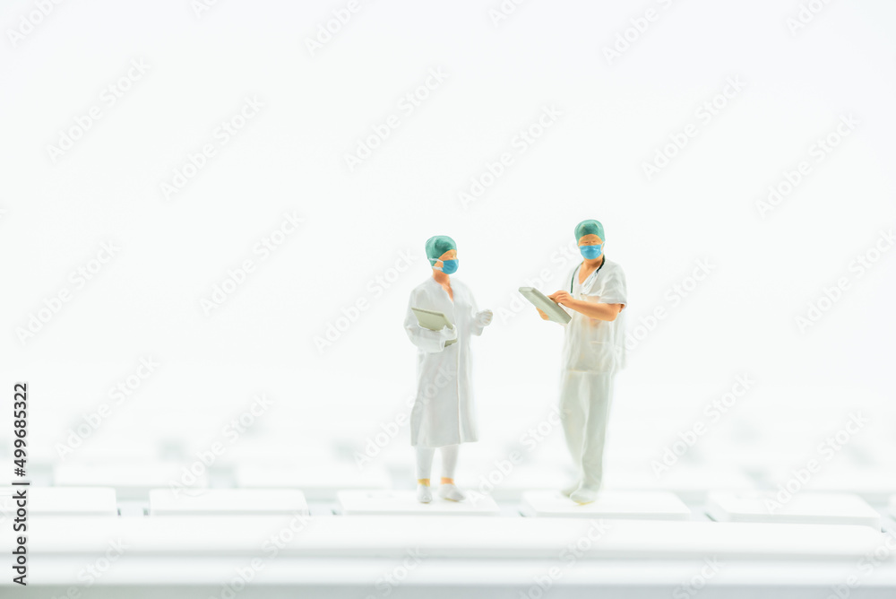 Telemedicine, telehealth or e-Health, healthcare concept : Physician or a doctor holds a patient history form, a nurse reviews data on a computer keyboard to provide advice and long-distance service. Telemedicine, telehealth or e-Health, healthcare concept : Physician or a doctor holds a patient history form, a nurse reviews data on a computer keyboard to provide advice and long-distance service.