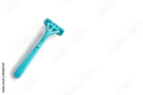 Disposable plastic razor on a white isolated background. Blue women's razor with free space for text on a white background arranged diagonally. Skin care razor and neat look concept