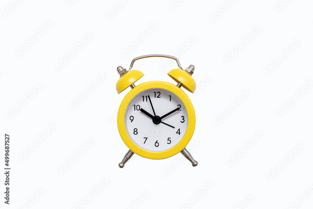 Yellow old-fashioned alarm clock with a dial on a white background with free space for text. The concept of punctuality or routine. Vintage alarm clock from the past Yellow old-fashioned alarm clock with a dial on a white background with free space for text. The concept of punctuality or routine. Vintage alarm clock from the past