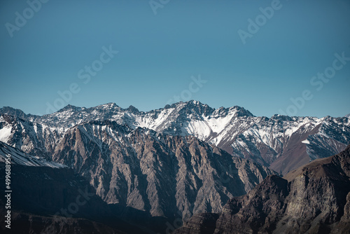Horizontal panoramic view of snow-capped mountain range in Caj  n del Maipo  Chile