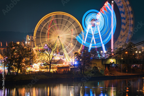 Spinning Ferris Wheels at  Fr  hlingsfest  at blue hour  Cannstatter Wasen  Stuttgart Germany 