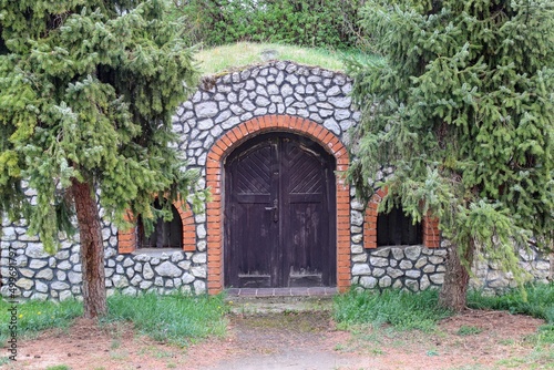 A wooden entrance to the wine cellar built with stones at Nosislav, Czech republic