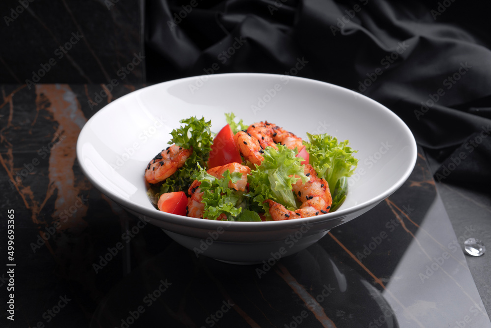 Shrimp salad on a black background and black cloth Shrimp salad on a black background and black cloth