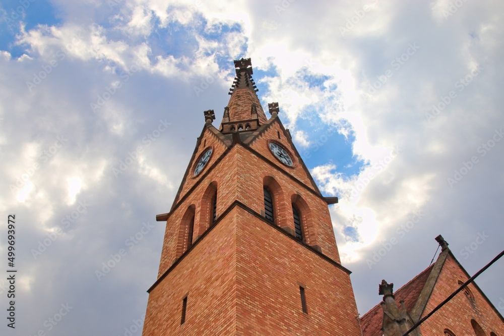 A view to the beautiful church built from little brown bricks and blue sky in background at Uhercice, Czech republic