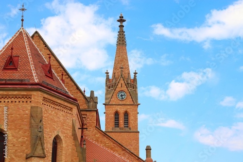 A view to the beautiful church built from little brown bricks and blue sky in background at Uhercice, Czech republic