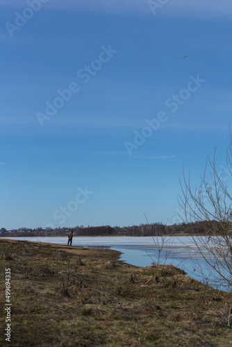 Fototapeta Naklejka Na Ścianę i Meble -  beautiful place, unknown man looking at nothing in a lake