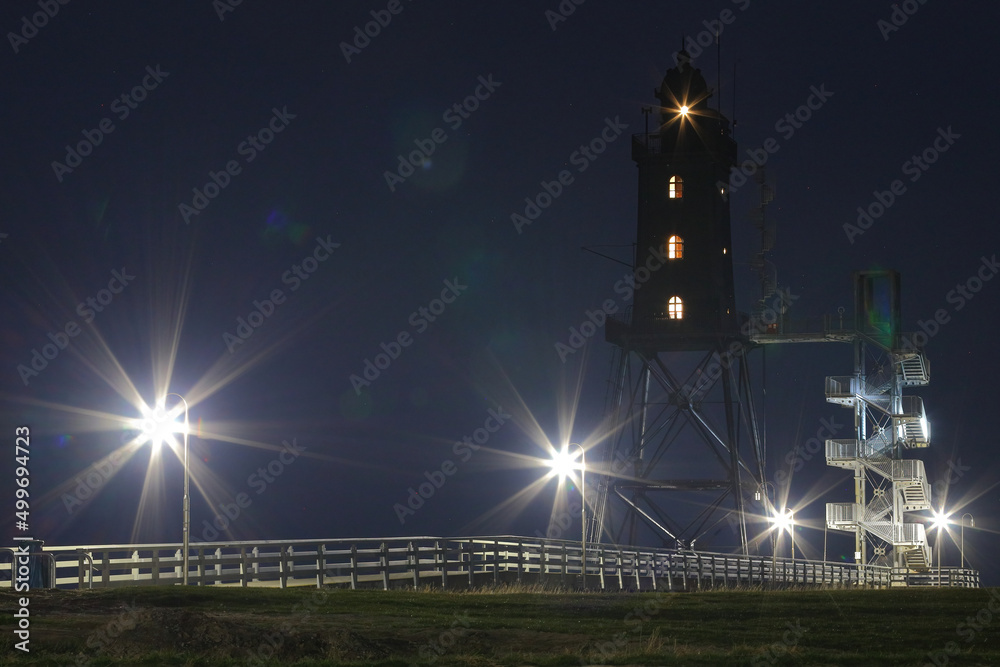 scenic night shot of an illuminated lighthouse