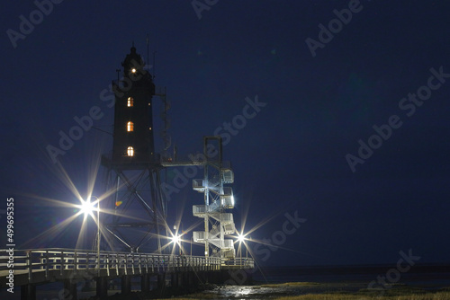 scenic night shot of an illuminated lighthouse photo