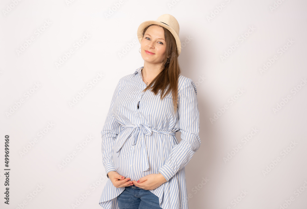 portrait of happy pregnant woman wearing straw hat isolated on white background. portrait of happy pregnant woman wearing straw hat isolated on white background.