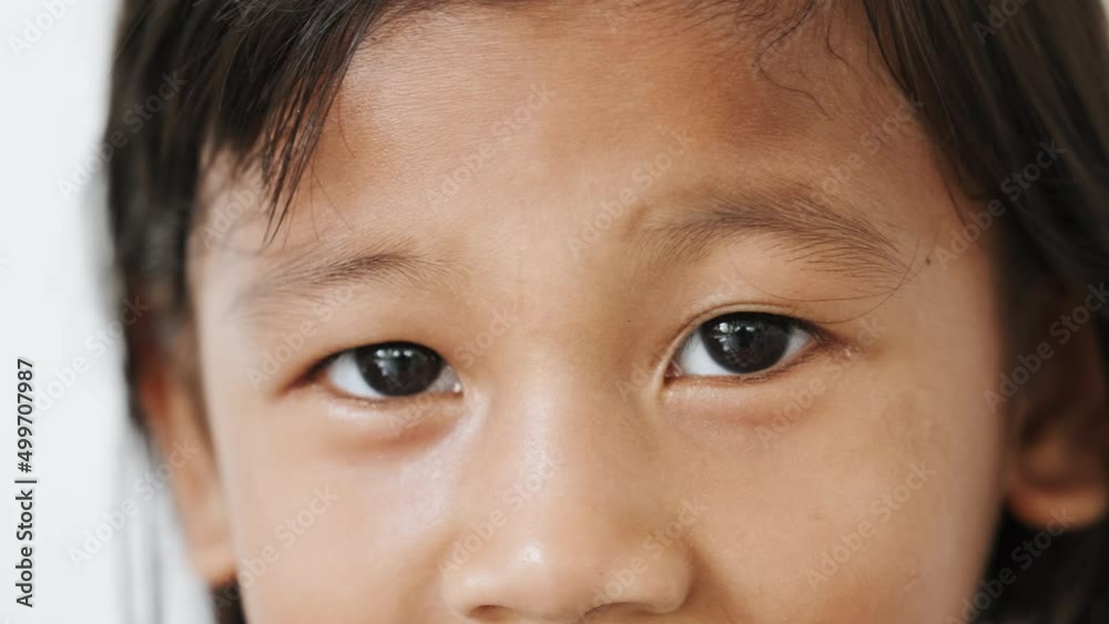 Small kid child looking in camera, eyes close-up. Face of asian girl. Shot for concept of Nationality Diversity, Ethnicity Differences and Nations Unity Small kid child looking in camera, eyes close-up. Face of asian girl. Shot for concept of Nationality Diversity, Ethnicity Differences and Nations Unity
