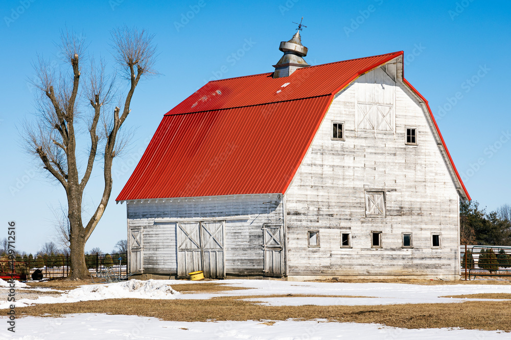 red roof barn in winter